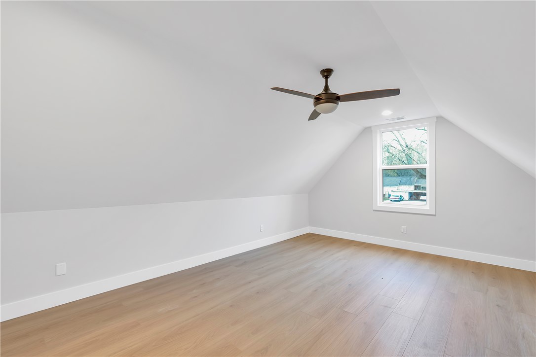 4554 Flat Rock Road Iva, SC 29655 - Photo 25 of 32 Sloped ceilings and a warm wooden floor define this versatile room, perfect for various uses.