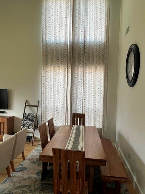 1407 Cartona Road Fate, TX 75087 - Photo 13 of 30 Spacious dining area featuring high ceilings and tall windows with sheer patterned curtains