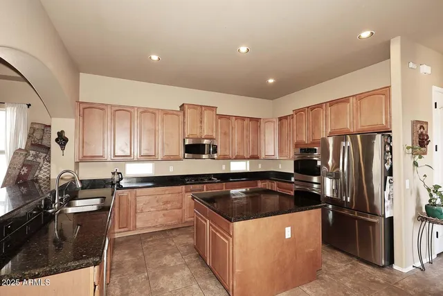 a kitchen with granite countertop a sink stove and cabinets