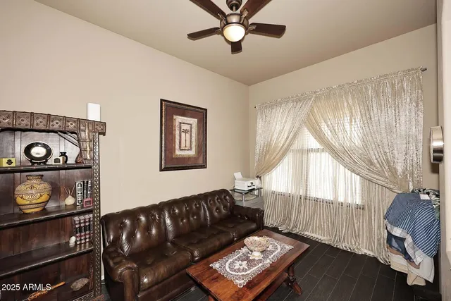 a dining room with furniture a chandelier and wooden floor