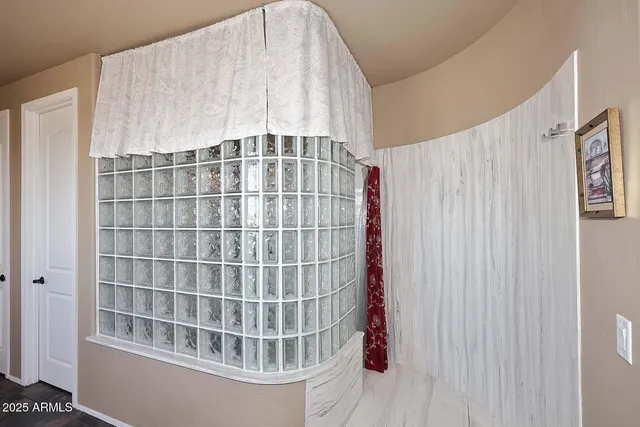 a room with pool table and windows