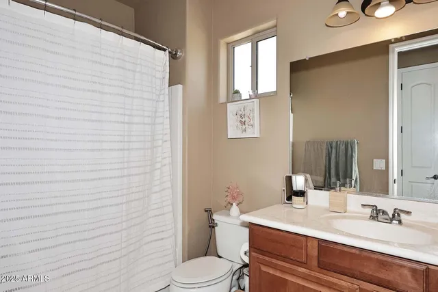 a bathroom with a toilet and a shower curtain