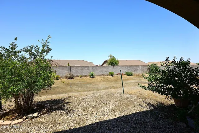 an aerial view of a house with a mountain