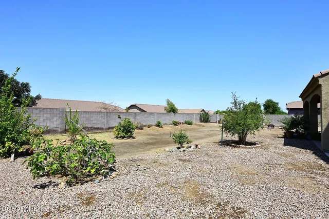 an aerial view of a house with yard and mountain view in back