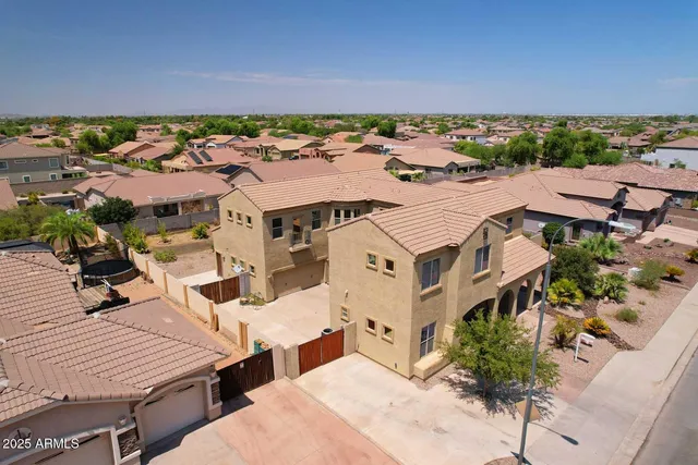 an aerial view of residential houses with outdoor space and parking