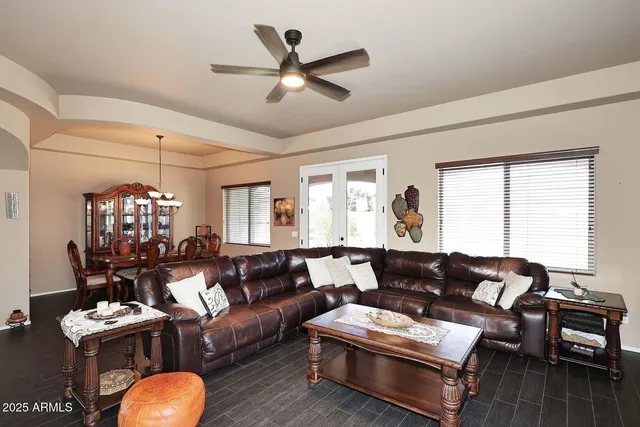 a living room with furniture a dining table and a fireplace