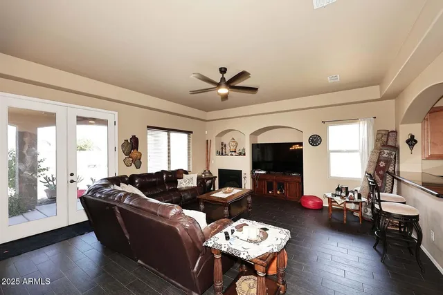 a living room with furniture and a chandelier