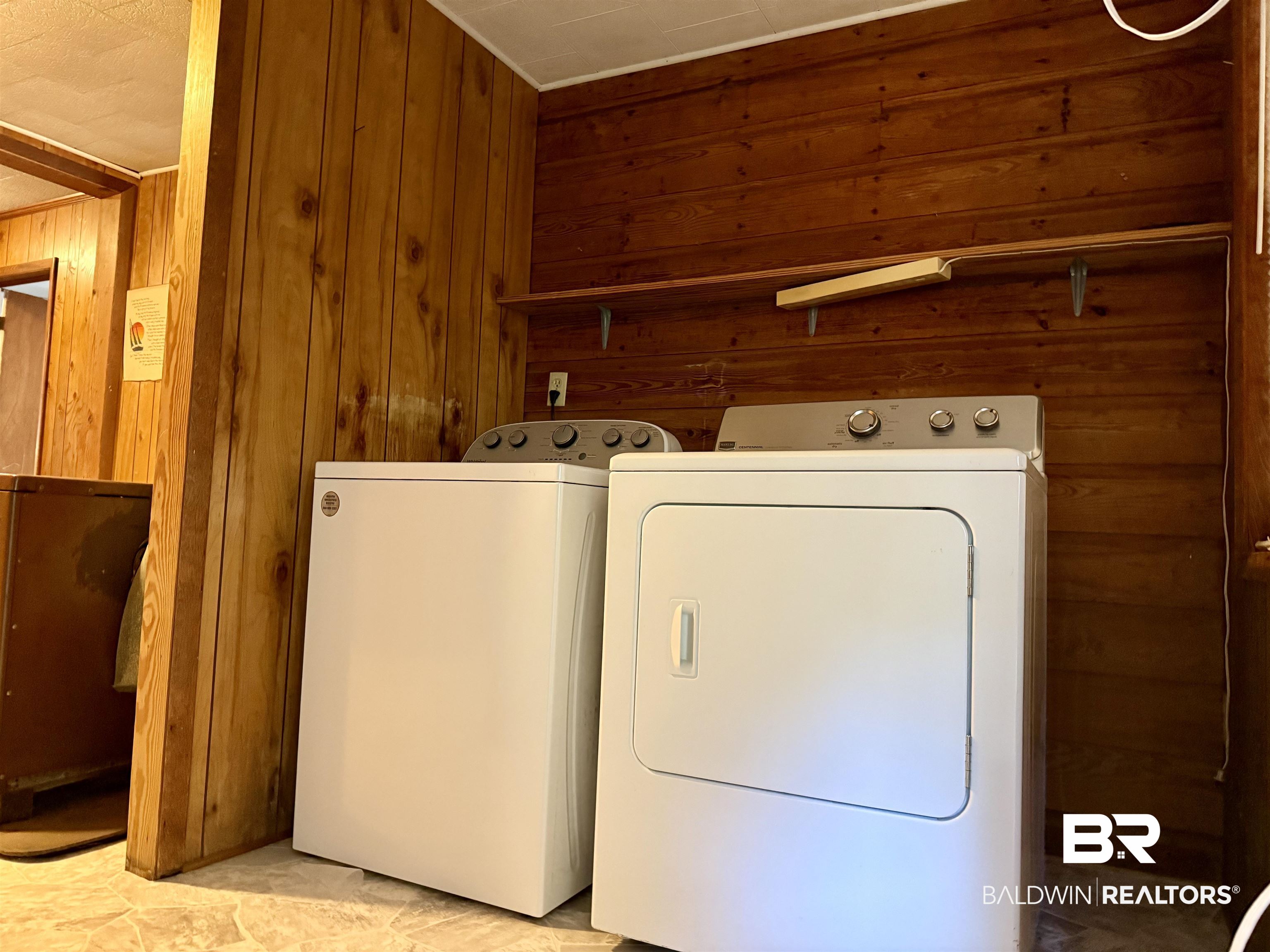 826 West Side Road Castleberry, AL 36432 - Photo 27 of 34 Laundry room featuring wooden walls and separate washer and dryer