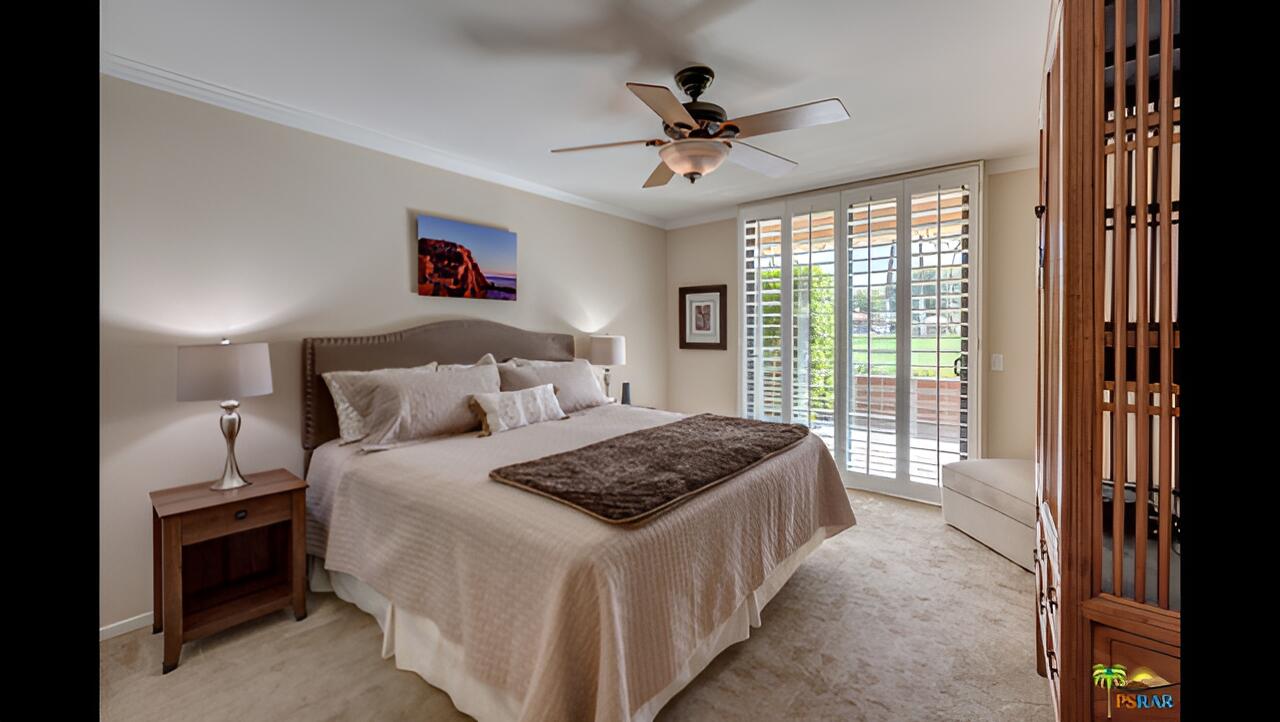 11 Palma Drive Rancho Mirage, CA 92270 - Photo 11 of 44 a bedroom with a large bed and a chandelier