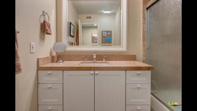 11 Palma Drive Rancho Mirage, CA 92270 - Photo 18 of 44 a bathroom with a granite countertop sink and a mirror