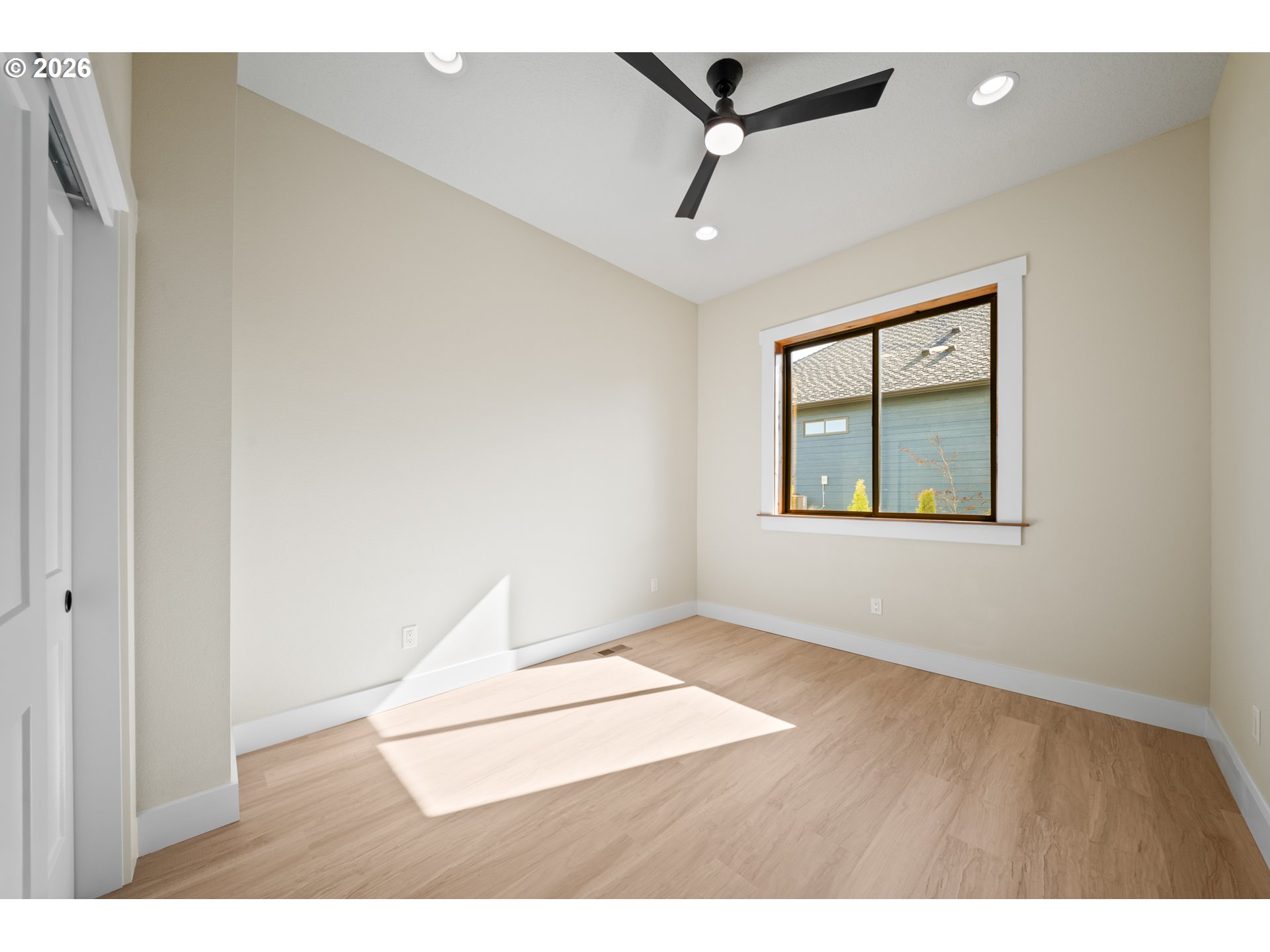 120 Victoria Circle Kalama, WA 98625 - Photo 16 of 44 an empty room with wooden floor ceiling fan and windows