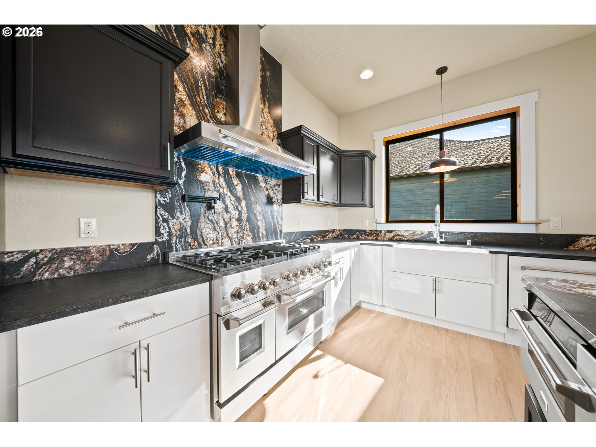 120 Victoria Circle Kalama, WA 98625 - Photo 10 of 44 a kitchen with stainless steel appliances granite countertop a sink and cabinets with wooden floor