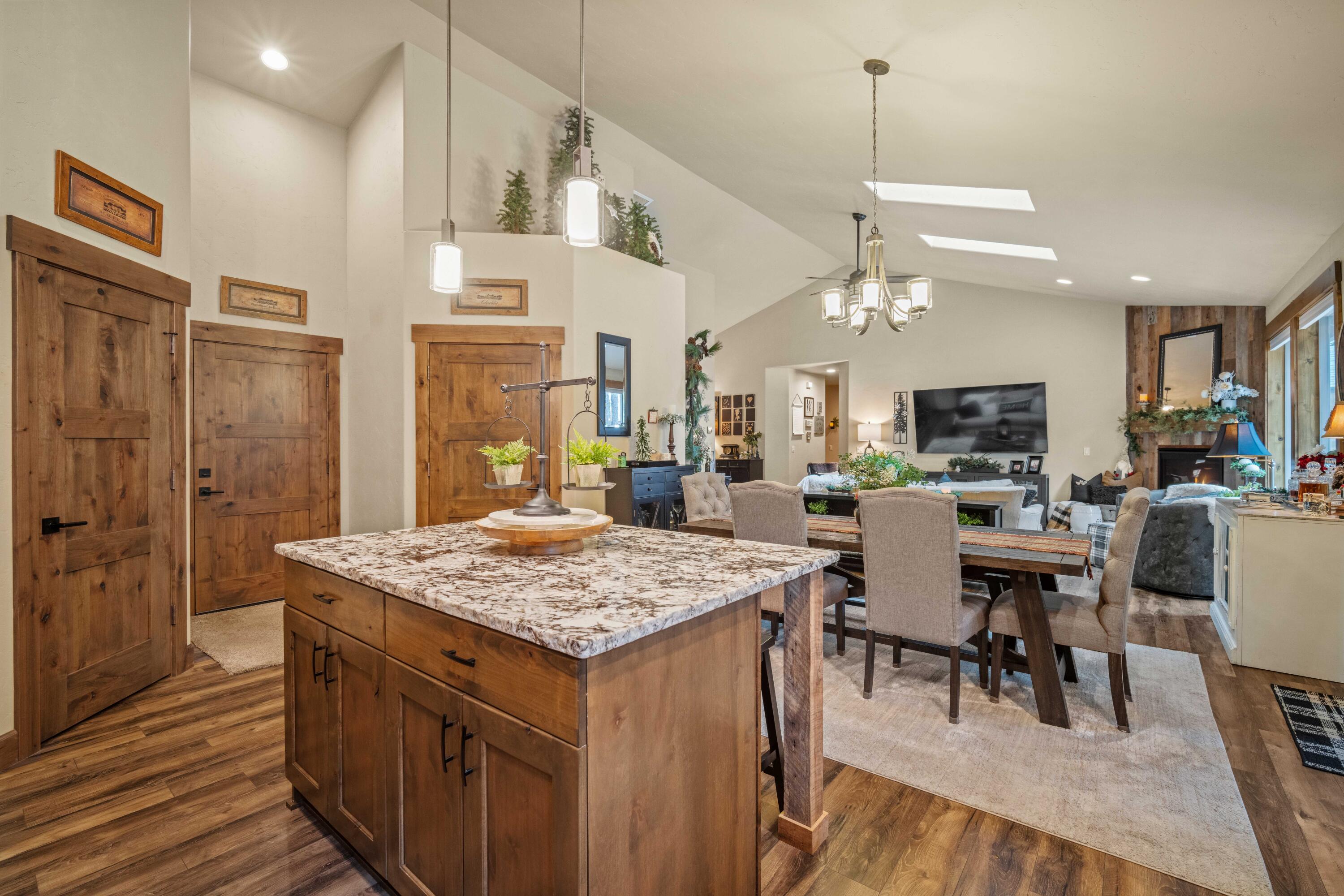 16927 Covina Road Bend, OR 97707 - Photo 12 of 54 Kitchen and dining area open seamlessly to the great room, showcasing the airy layout and connected living spaces that define this exceptional home.