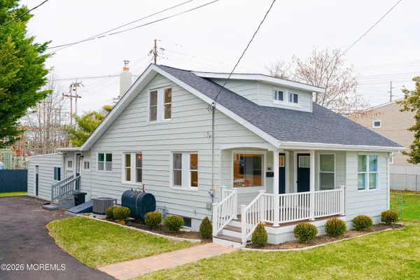 a view of house with a yard chairs