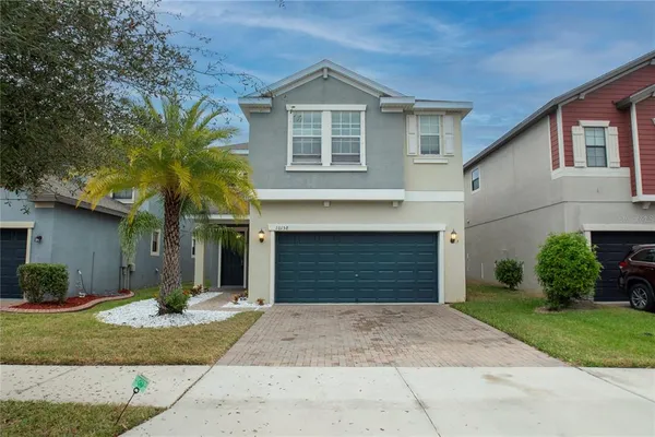 a front view of a house with a yard and garage