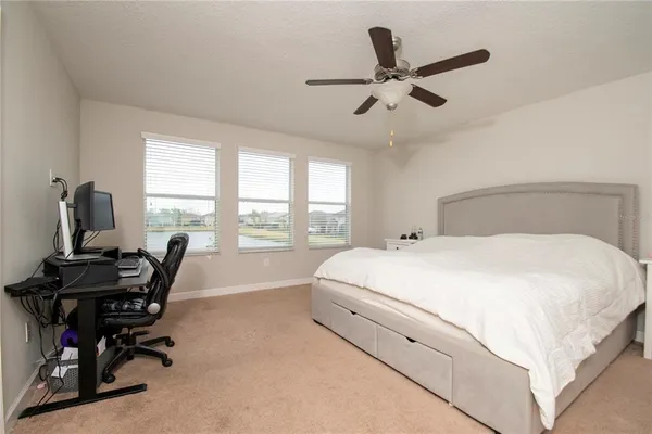 a bed room with a bed and a desk