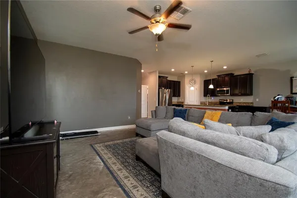 a living room with furniture ceiling fan and a rug