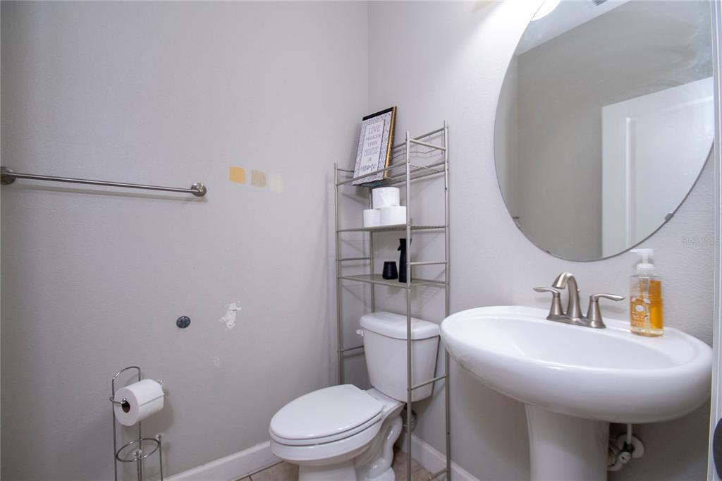 10158 Newminster Loop Ruskin, FL 33573 - Photo 7 of 12 a bathroom with a toilet sink and mirror