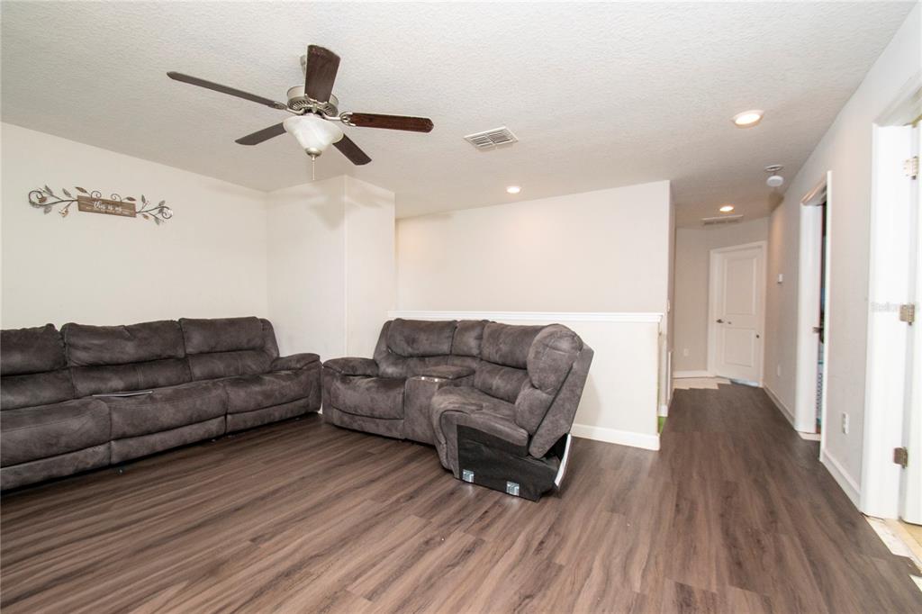 10158 Newminster Loop Ruskin, FL 33573 - Photo 8 of 12 a living room with couches and a coffee table
