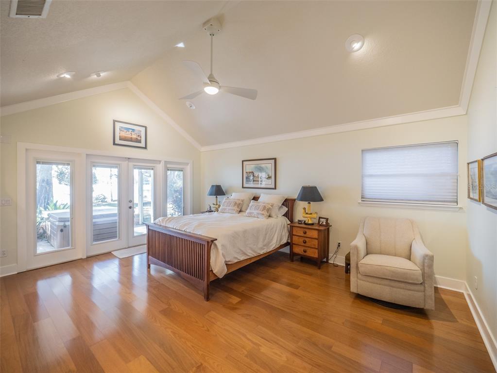 1444 Pelican Bay Trail Winter Park, FL 32792 - Photo 11 of 57 a spacious bedroom with a bed and wooden floor