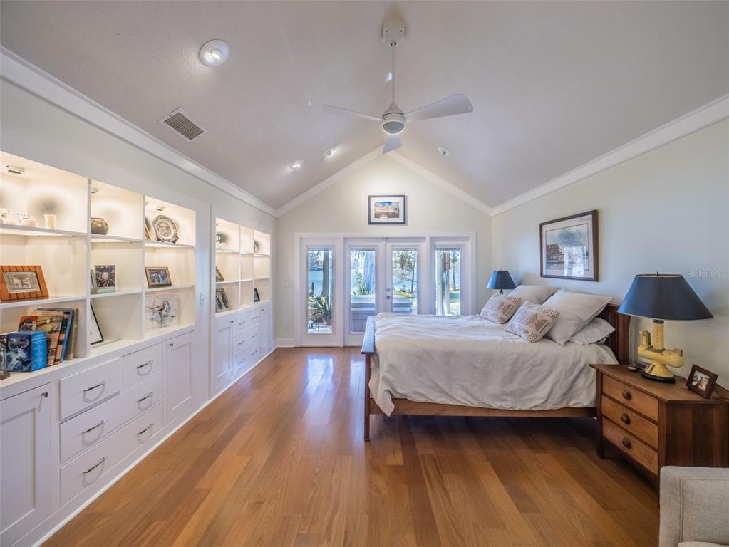 1444 Pelican Bay Trail Winter Park, FL 32792 - Photo 24 of 57 a bedroom with a large bed and a wooden floor