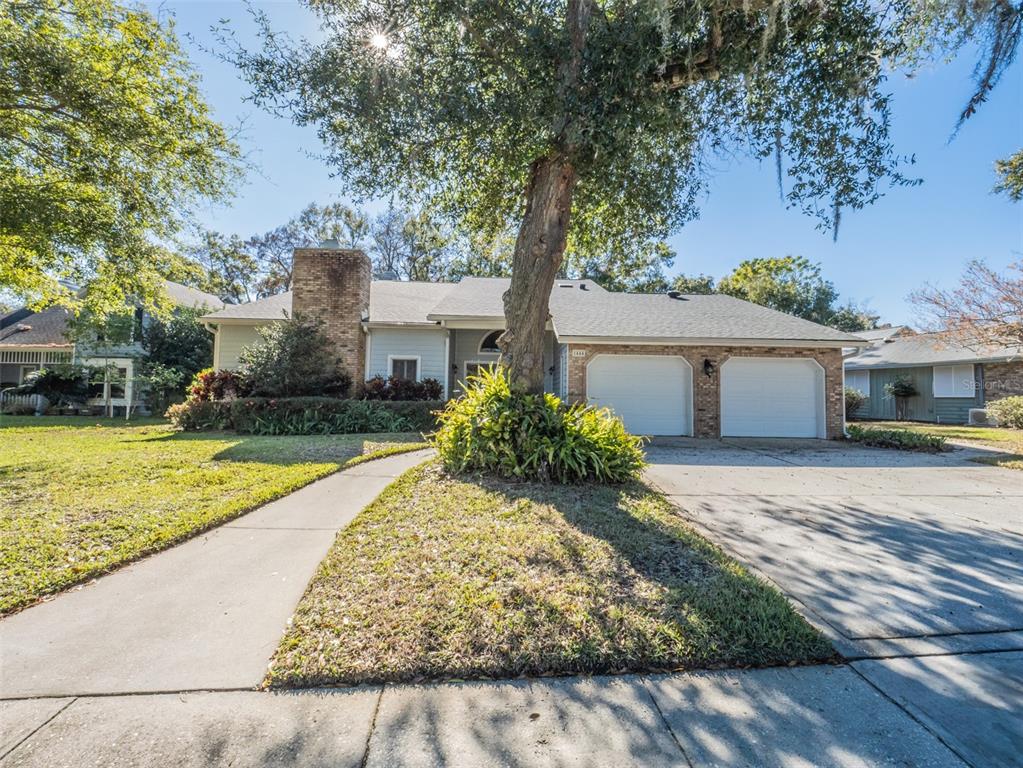 1444 Pelican Bay Trail Winter Park, FL 32792 - Photo 3 of 57 a view of a house with a yard and large tree