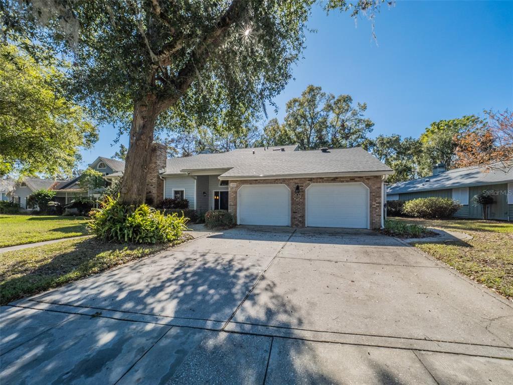 1444 Pelican Bay Trail Winter Park, FL 32792 - Photo 4 of 57 a front view of a house with a yard and garage