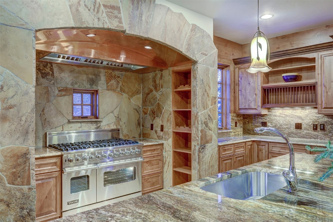 72 Snowy Ridge Road Breckenridge, CO 80424 - Photo 11 of 40 a kitchen with stainless steel appliances granite countertop a stove and a sink