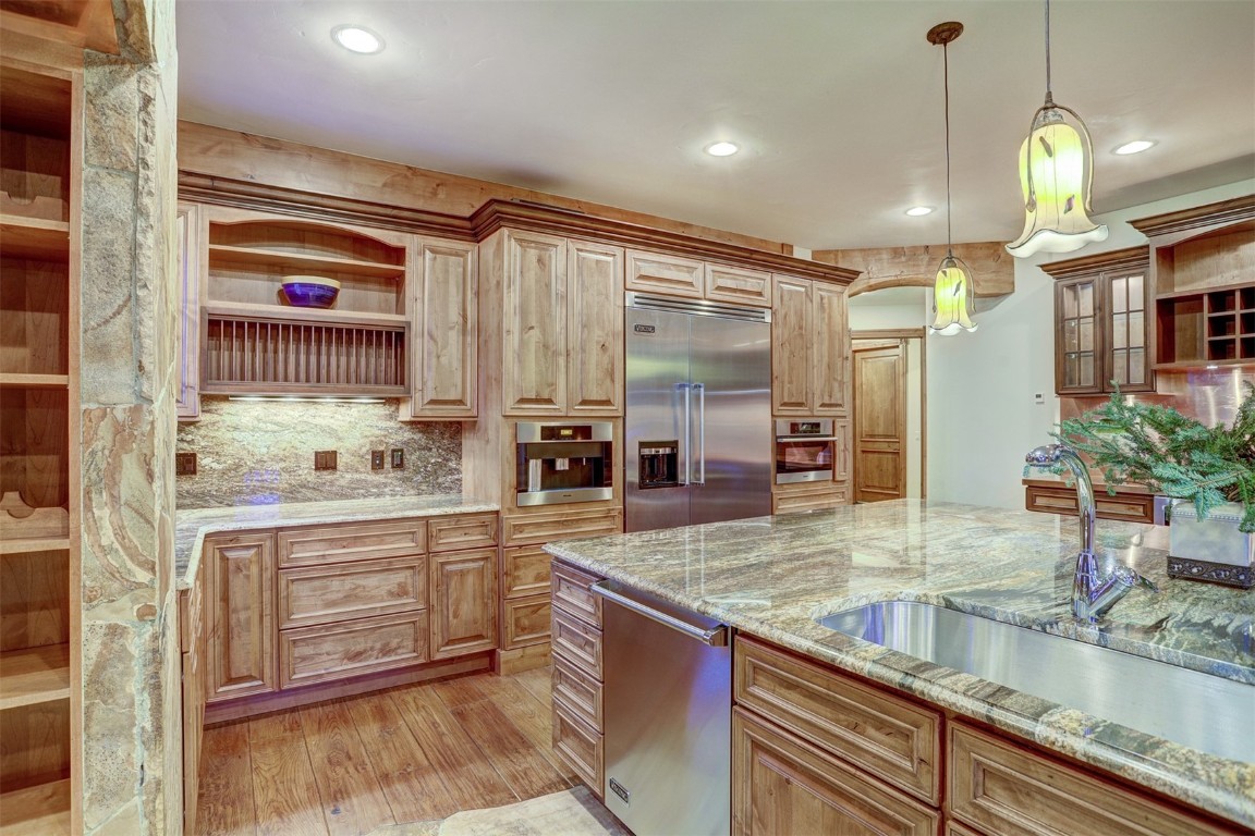 72 Snowy Ridge Road Breckenridge, CO 80424 - Photo 10 of 40 a kitchen with stainless steel appliances granite countertop a sink and a refrigerator