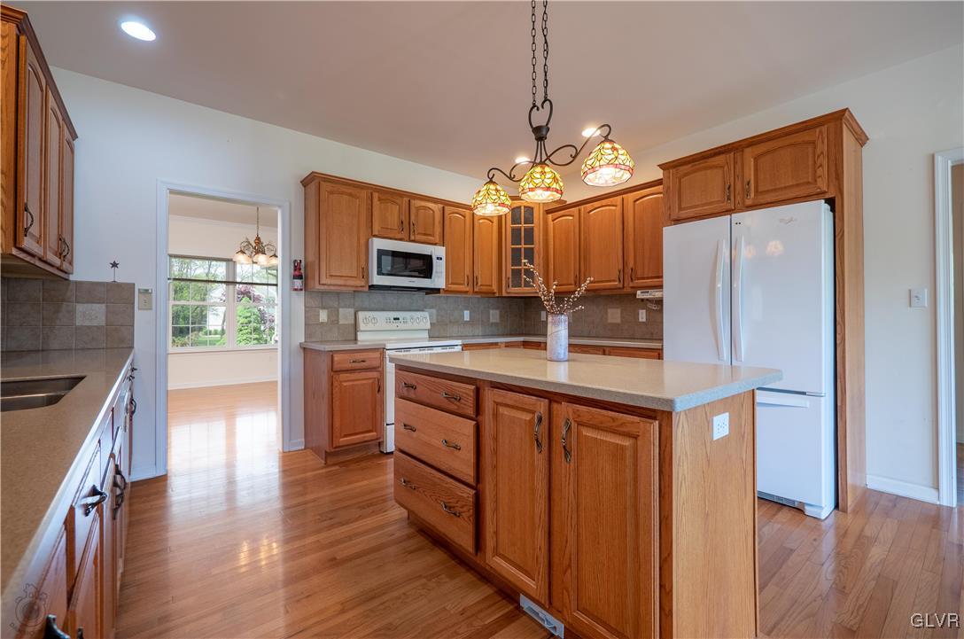 212 Bushkill Ridge Road Wind Gap, PA 18091 - Photo 13 of 36 a kitchen with kitchen island granite countertop stainless steel appliances cabinets a sink and a chandelier
