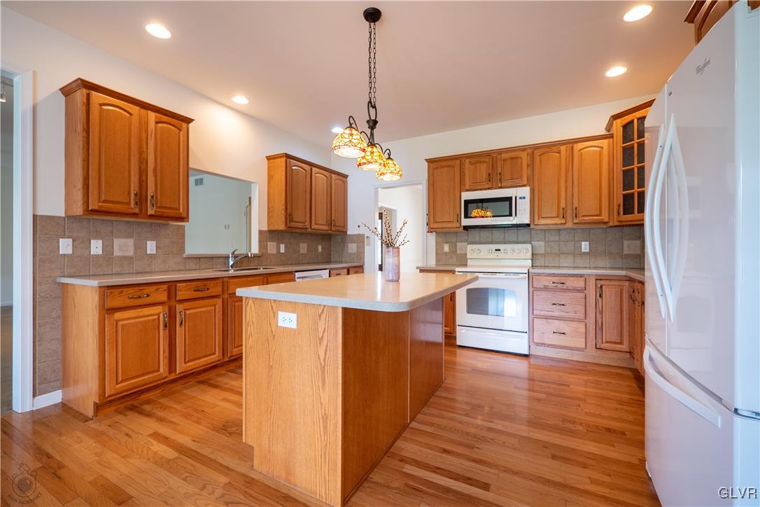 212 Bushkill Ridge Road Wind Gap, PA 18091 - Photo 14 of 36 a kitchen with stainless steel appliances kitchen island granite countertop a stove a sink dishwasher and a microwave oven with wooden floor