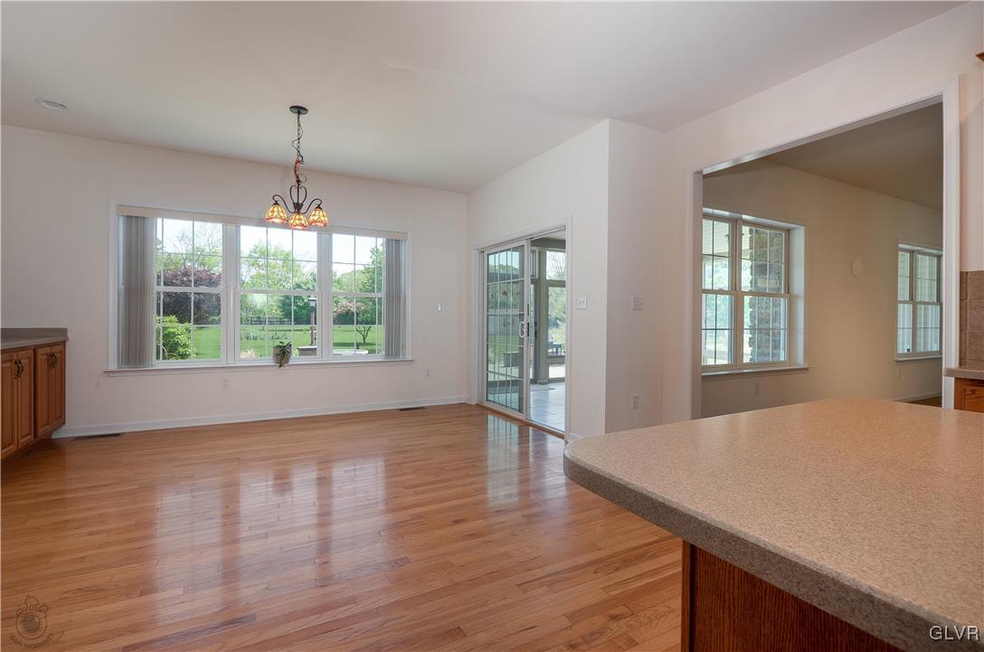 212 Bushkill Ridge Road Wind Gap, PA 18091 - Photo 15 of 36 a view of an empty room with window wooden floor and chandelier