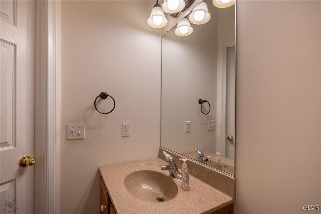 212 Bushkill Ridge Road Wind Gap, PA 18091 - Photo 19 of 36 a bathroom with a sink a light fixture and a mirror