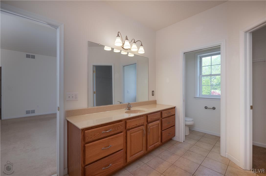 212 Bushkill Ridge Road Wind Gap, PA 18091 - Photo 21 of 36 a bathroom with a granite countertop sink a toilet and a mirror