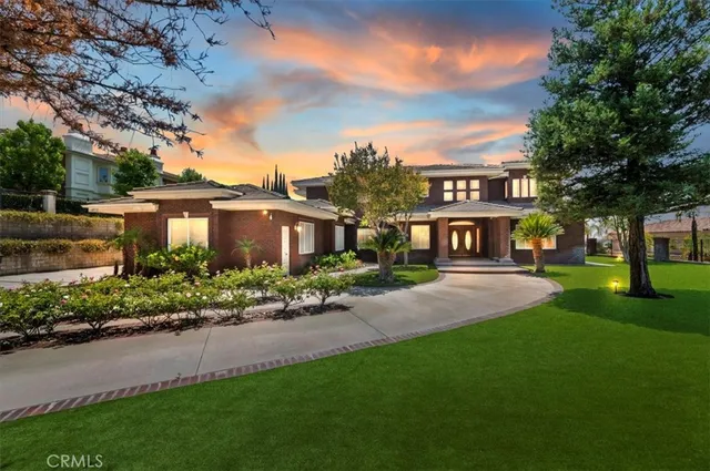a front view of a house with yard and green space