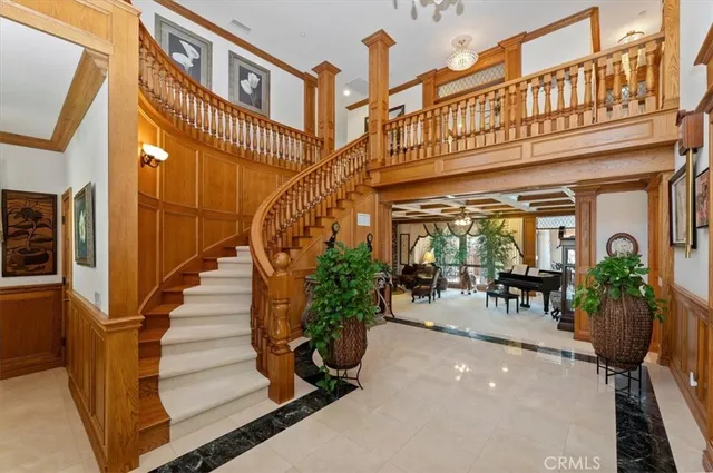 a view of a dining room with furniture a chandelier and wooden floor