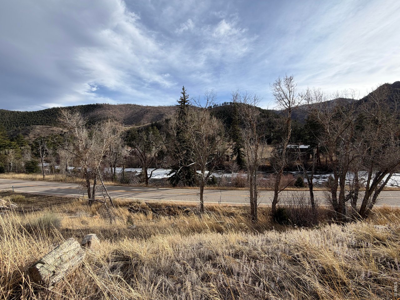 32370 Poudre Canyon Road Bellvue, CO 80512 - Photo 20 of 30 a view of a yard with wooden fence
