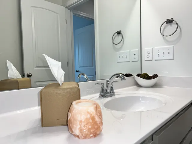 a bathroom with a double vanity sink and a mirror