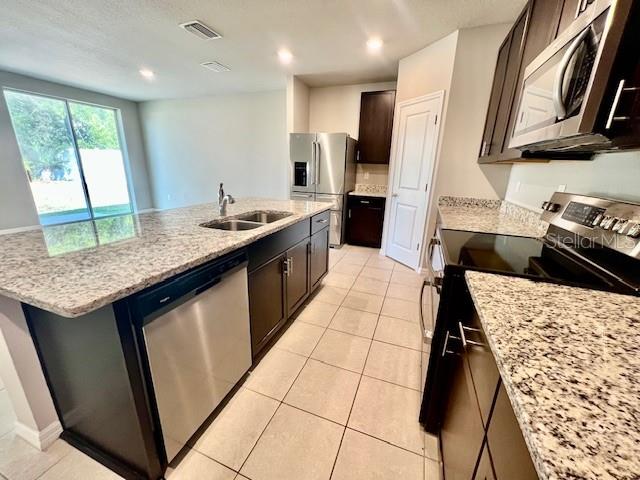 1251 McNeal Road Spring Hill, FL 34608 - Photo 14 of 46 a kitchen with a sink stove and refrigerator