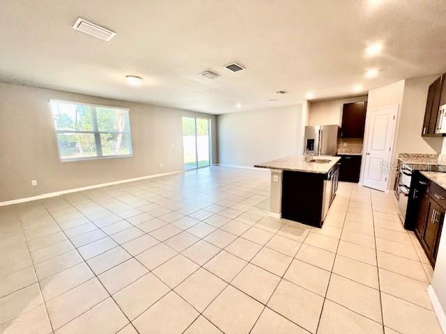 1251 McNeal Road Spring Hill, FL 34608 - Photo 15 of 46 a large white kitchen with a stove a sink dishwasher and a refrigerator