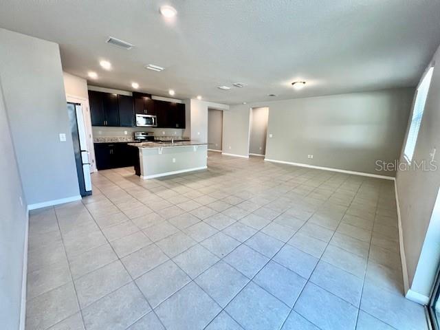1251 McNeal Road Spring Hill, FL 34608 - Photo 18 of 46 a view of kitchen with stainless steel appliances kitchen island granite countertop a refrigerator a stove and a sink
