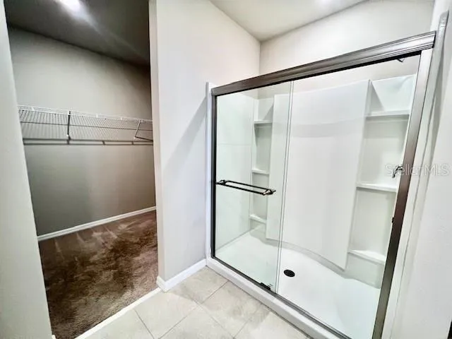 a bathroom with a glass shower door