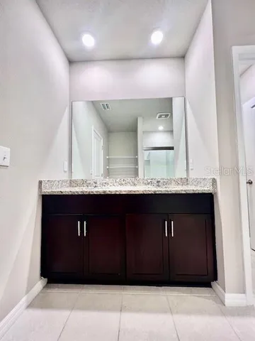 a bathroom with a sink double vanity and a mirror