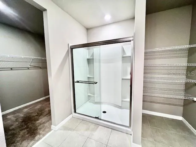 a bathroom with a glass shower door