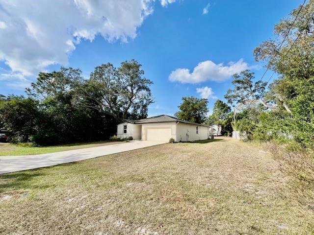 1251 McNeal Road Spring Hill, FL 34608 - Photo 43 of 46 a front view of a house with a yard