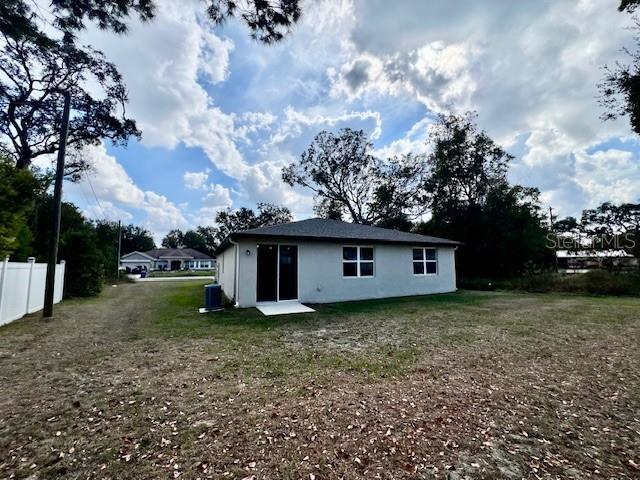 1251 McNeal Road Spring Hill, FL 34608 - Photo 44 of 46 a view of a backyard with large trees