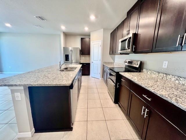 1251 McNeal Road Spring Hill, FL 34608 - Photo 5 of 46 a kitchen with stainless steel appliances granite countertop a sink stove and refrigerator