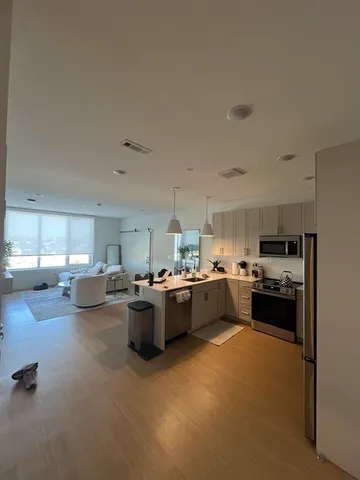 a kitchen with sink refrigerator and stove