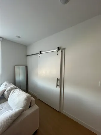 a living room with furniture and a glass door