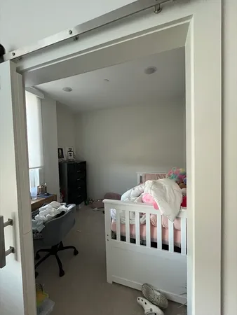 a bedroom with furniture and a window